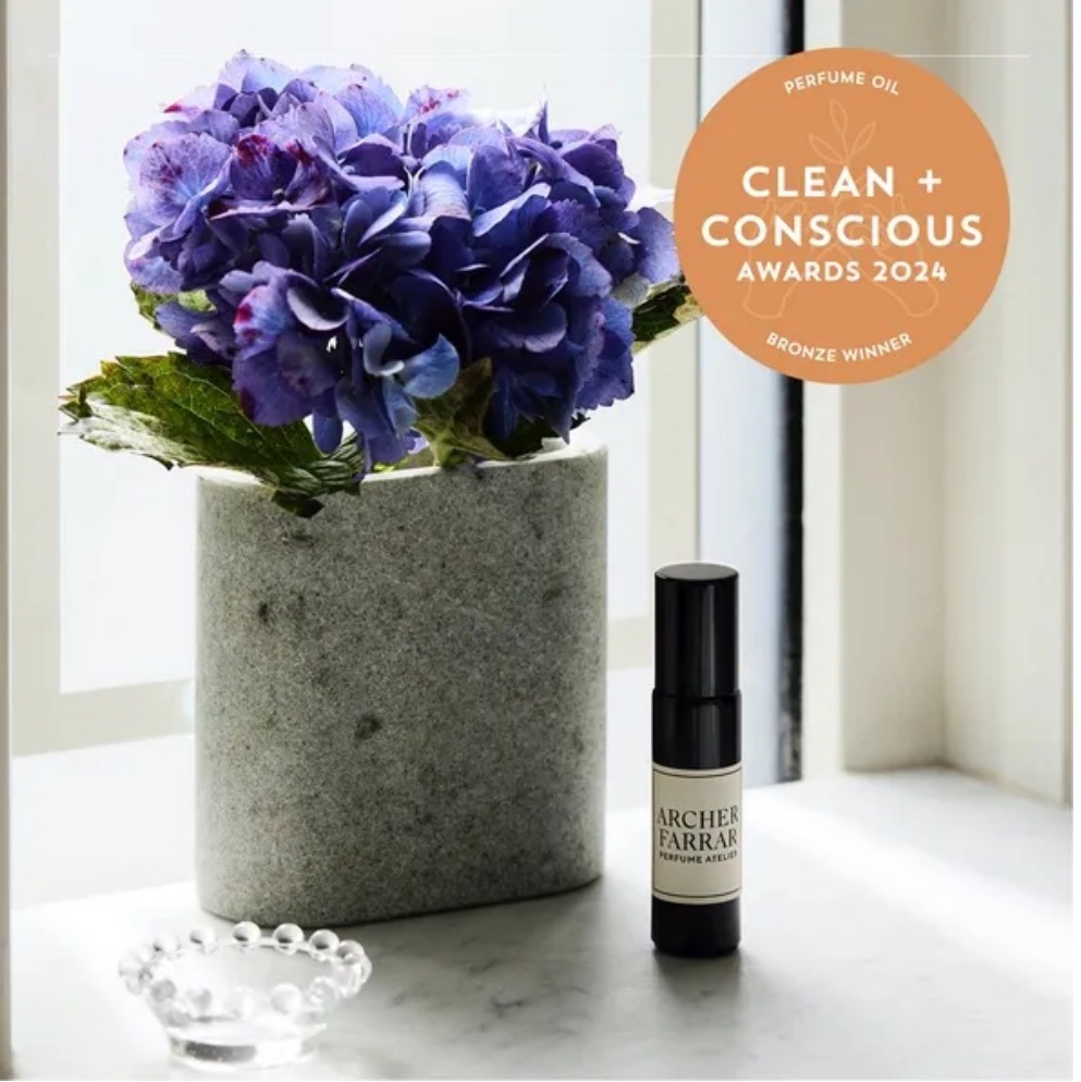 Embrace oil perfume with flowers and bronze Clean + Conscious Award